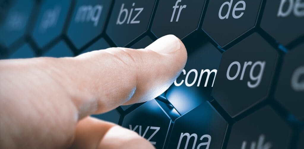Man selecting a domain extention by pressing an hexagonal button after choosing a name for a webste. Composite image between a hand photography and a 3D background.