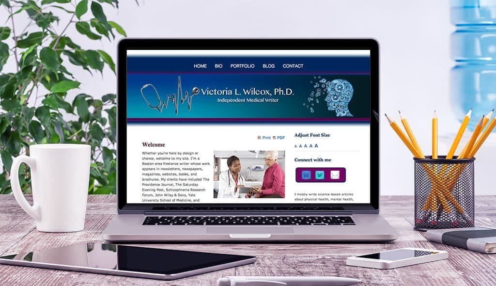 laptop displaying the home page of Victoria Wilcox