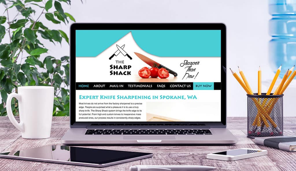 laptop displaying the home page of Sharp Shack