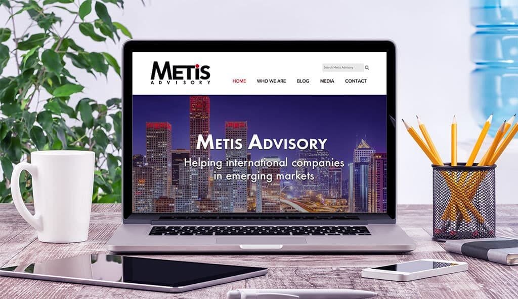 laptop displaying the home page of Metis Advisory