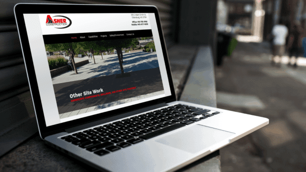 Contractor Website - laptop displaying Asher Construction home page