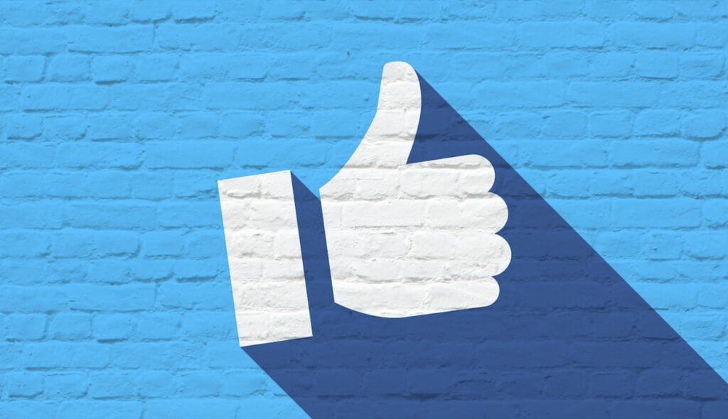 Thumbs up on bricks wall Facebook reach