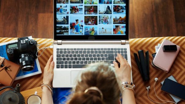 woman looks at image while transferring photos from DSLR camera