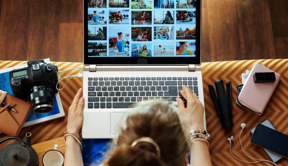 woman looks at image while transferring photos from DSLR camera