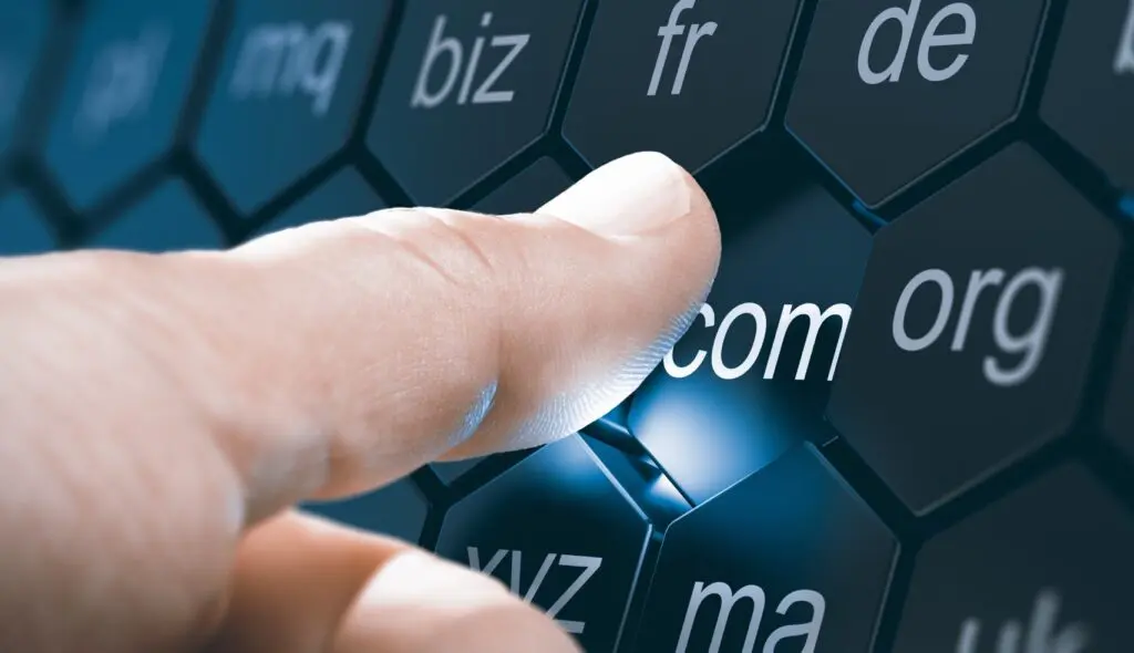 Registrar, Domain Name Registration. Man selecting a domain extention by pressing an hexagonal button. Composite image between a hand photography and a 3D background.