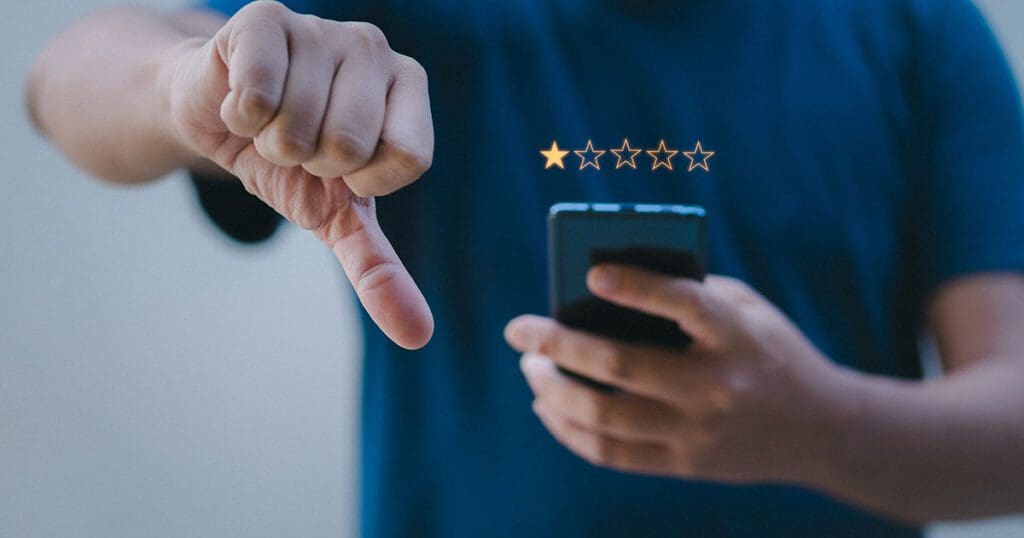 Person leaving a bad Google review with a thumbs down.