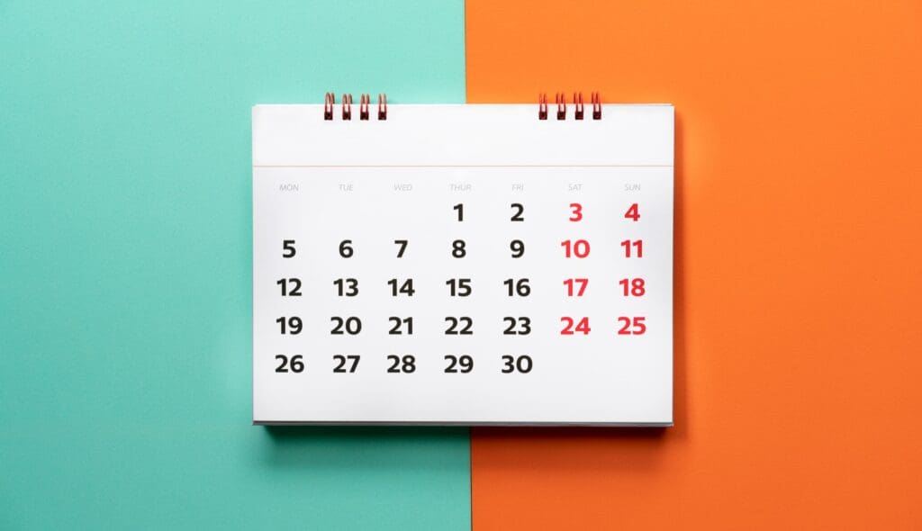 close up of calendar on the color table, planning for business meeting or travel planning concept Calendar graphic to represent using Calendly with WordPress