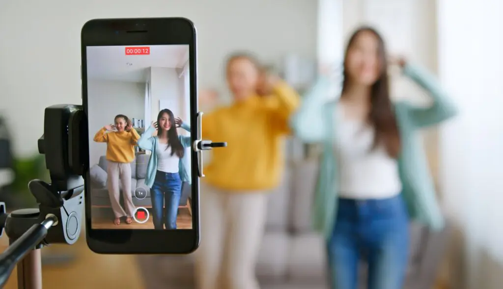 Girls making a TikTok video after learning how can TikTok help your business. Girls making a TikTok video after learning how can TikTok help your business