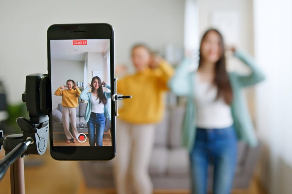 Girls making a TikTok video after learning how can TikTok help your business