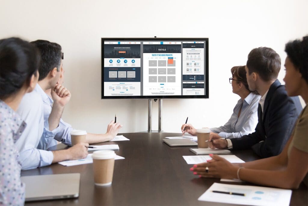 Business people looking at examples of Corporate Website Design
