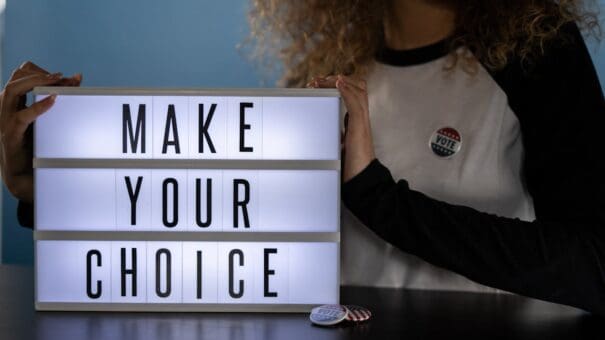 Person holding a sign | Political campaign website