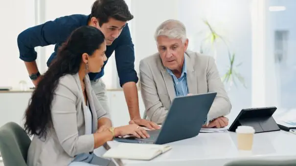 A man working on digital estate planning with two helpers.