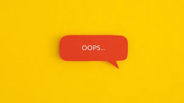 Paper speech bubble with the word "OOPS" on a yellow background