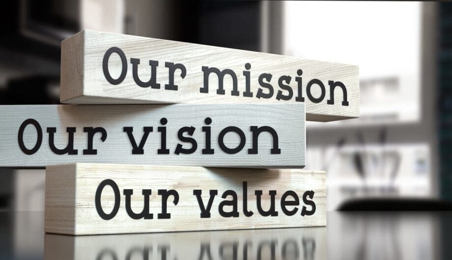 Our mission, vision, values - words on wooden blocks - 3D illustration Blocks that read Our Mission, Our Vision, Our Values to represent an about us page
