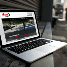 Contractor Website - laptop displaying Asher Construction home page