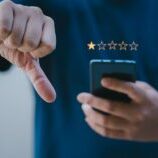 Person leaving a bad Google review with a thumbs down.