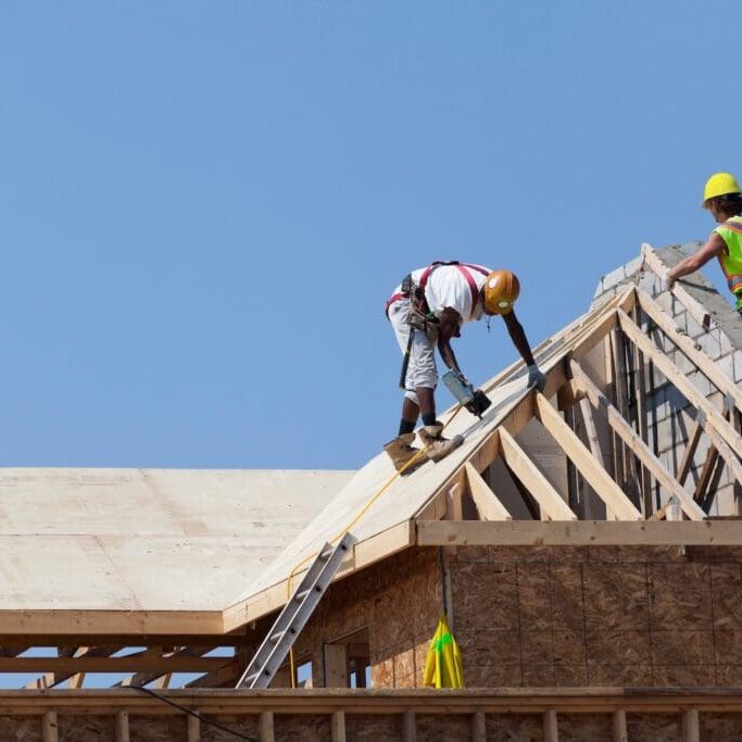 Workers working on the roof Home being built | Construction Company Web Design