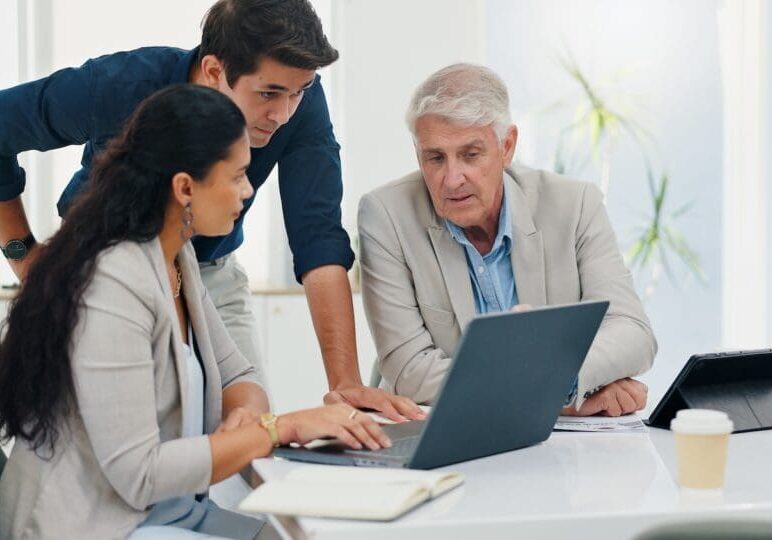 A man working on digital estate planning with two helpers.