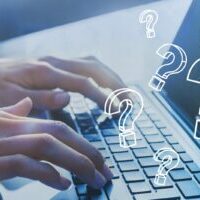 Question marks over keyboard representing questions you might have before starting seo | FAQ page |