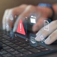 Fingers on keyboard, with icons showing errors and issues