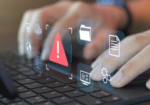 Fingers on keyboard, with icons showing errors and issues