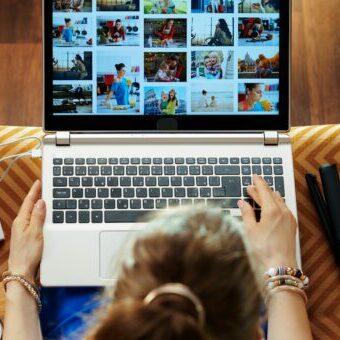 woman looks at image while transferring photos from DSLR camera