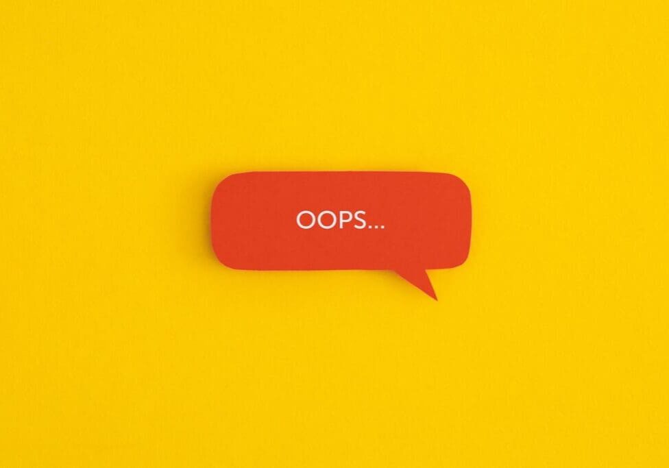 Paper speech bubble with the word "OOPS" on a yellow background