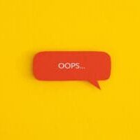 Paper speech bubble with the word "OOPS" on a yellow background
