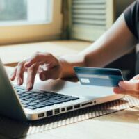 Person Paying with Credit Card as they learn how to set up woocommerce payments