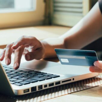 the girl is shopping on the Internet Person Paying with Credit Card as they learn how to set up woocommerce payments