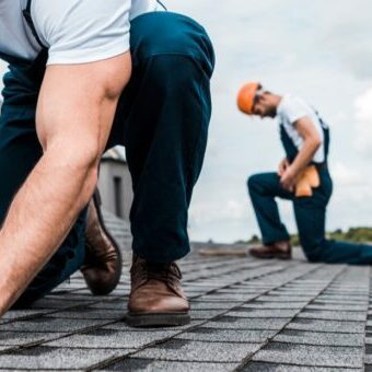 A roofer nailing a shingle A roofer nailing a shingle to represent roofing website design