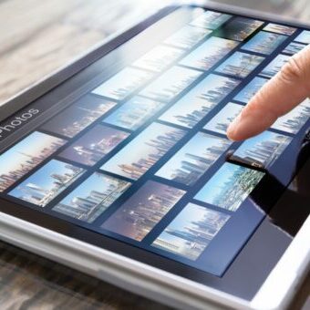 Editor Searching Photos On Tablet Searching for stock photo