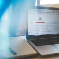 Google Analytics data shown on a laptop.